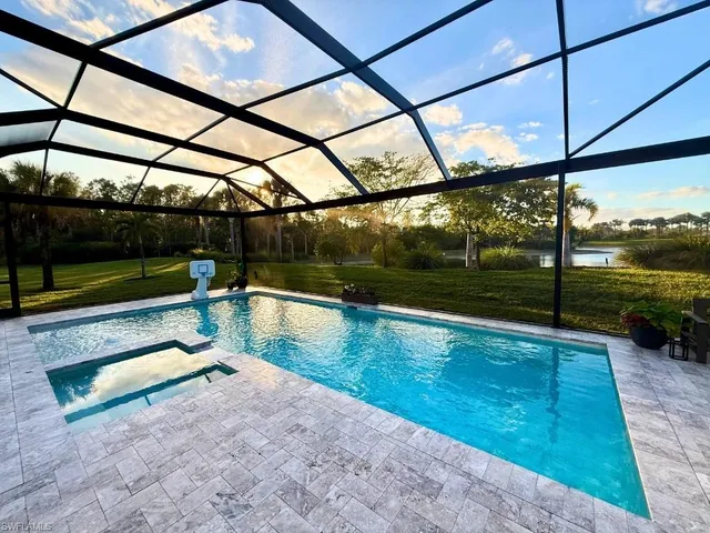 a view of a swimming pool with a yard