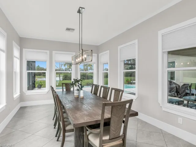 a view of a dining room with furniture large windows and wooden floor