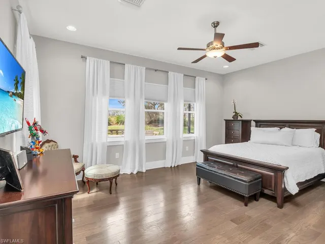 a spacious bedroom with a bed and a table in it