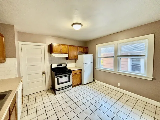 a kitchen with stainless steel appliances a refrigerator and a stove top oven