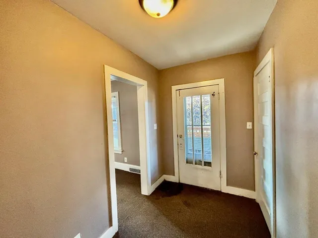 a view of an empty room with glass door