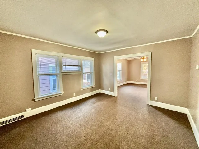 an empty room with a empty space and windows