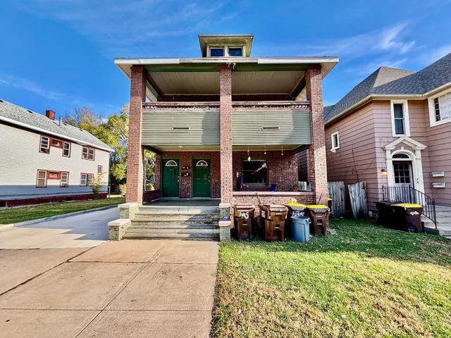 a view of a house with a yard and sitting area