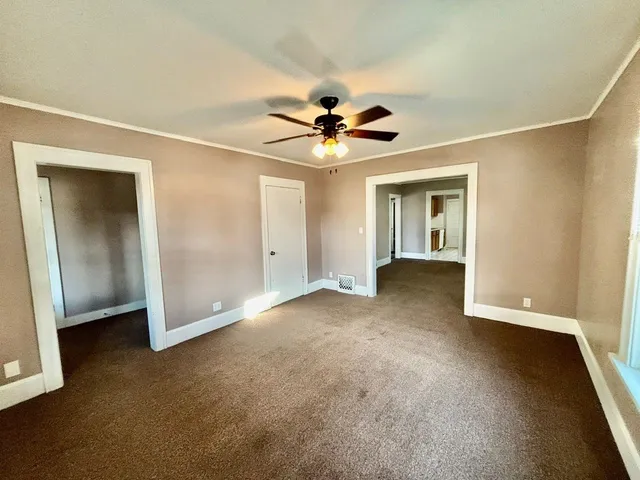 a view of a livingroom with a ceiling fan and chandelier fan