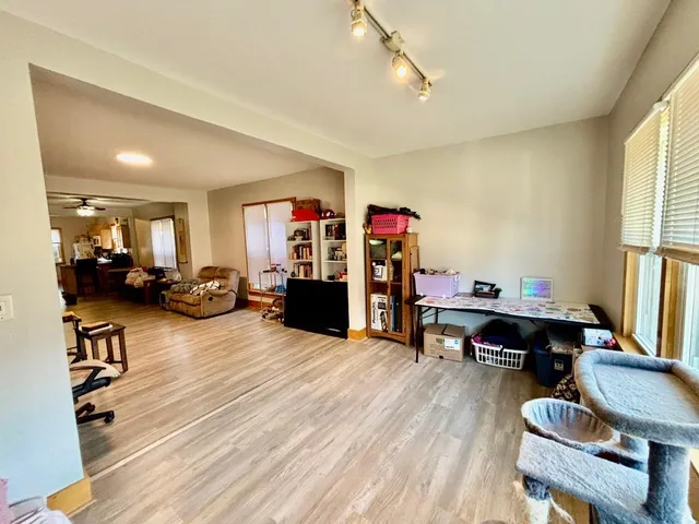 a room with furniture pool table and window