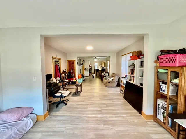 a living room filled with furniture and a wooden floor