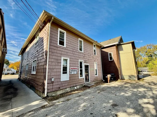 a view of a house with wooden walls and stairs