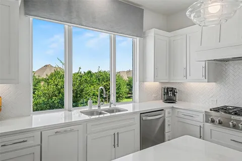 a kitchen with a sink stove and cabinets