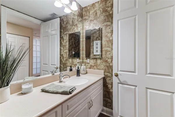 a spacious bathroom with a double vanity sink a mirror and a shower