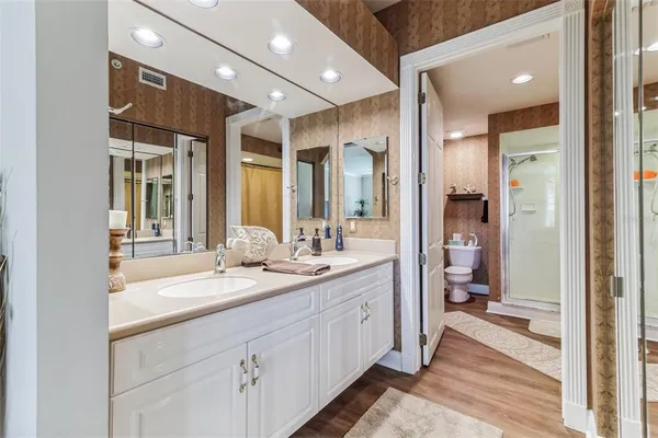 a bathroom with a toilet and a shower