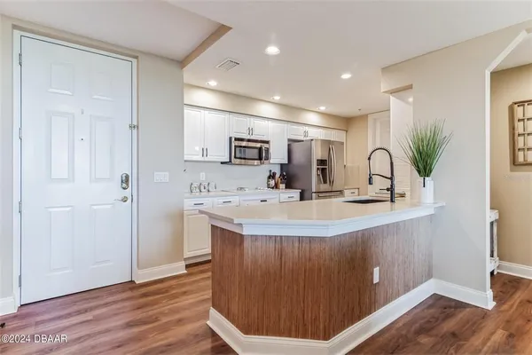 a large kitchen with stainless steel appliances lots of counter space and a sink