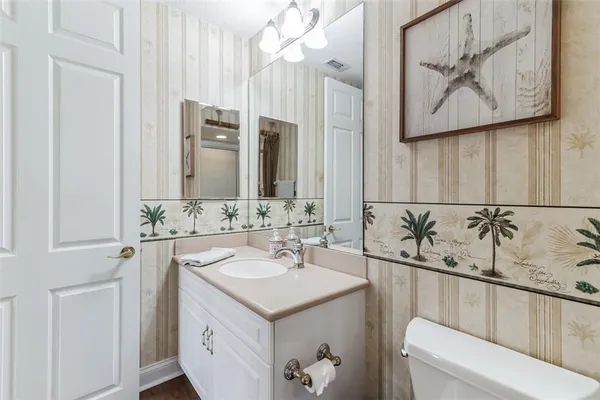 a spacious bedroom with a bed and a flat screen tv