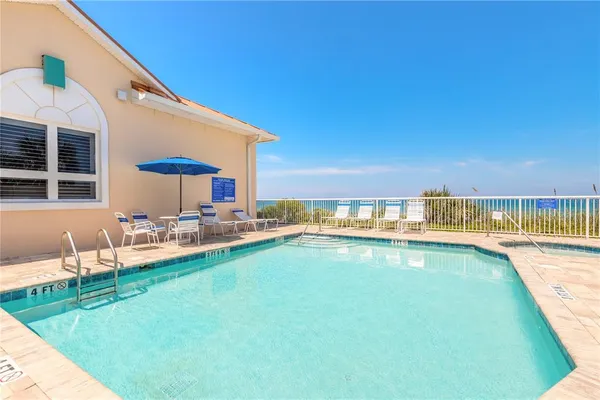 a view of a patio with wooden floor and fence