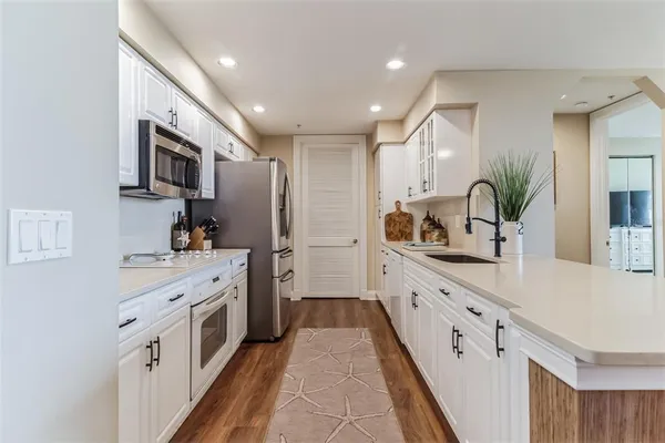 a spacious bathroom with a double vanity sink and mirror