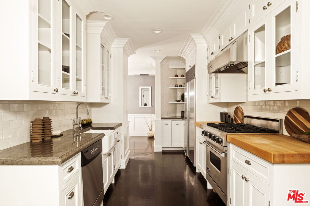 8455 Fountain Avenue, Unit 411 West Hollywood, CA 90069 - Photo 12 of 27 a kitchen with stainless steel appliances granite countertop a stove and a sink