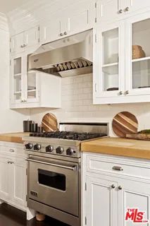 a kitchen with stainless steel appliances granite countertop a stove and a sink