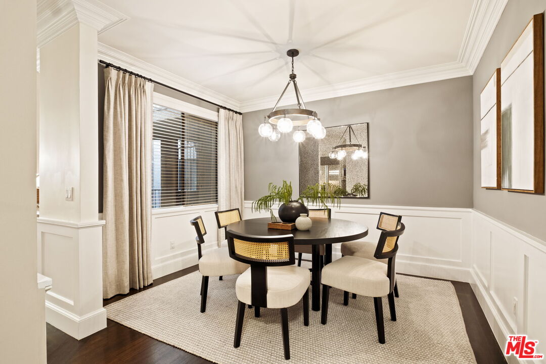 8455 Fountain Avenue, Unit 411 West Hollywood, CA 90069 - Photo 14 of 27 a dining room with furniture a chandelier and wooden floor