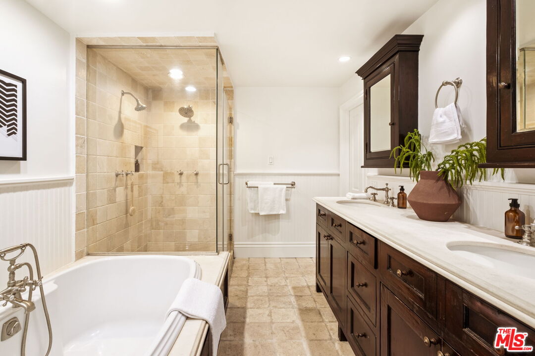 8455 Fountain Avenue, Unit 411 West Hollywood, CA 90069 - Photo 19 of 27 a spacious bathroom with a granite countertop tub sink and mirror