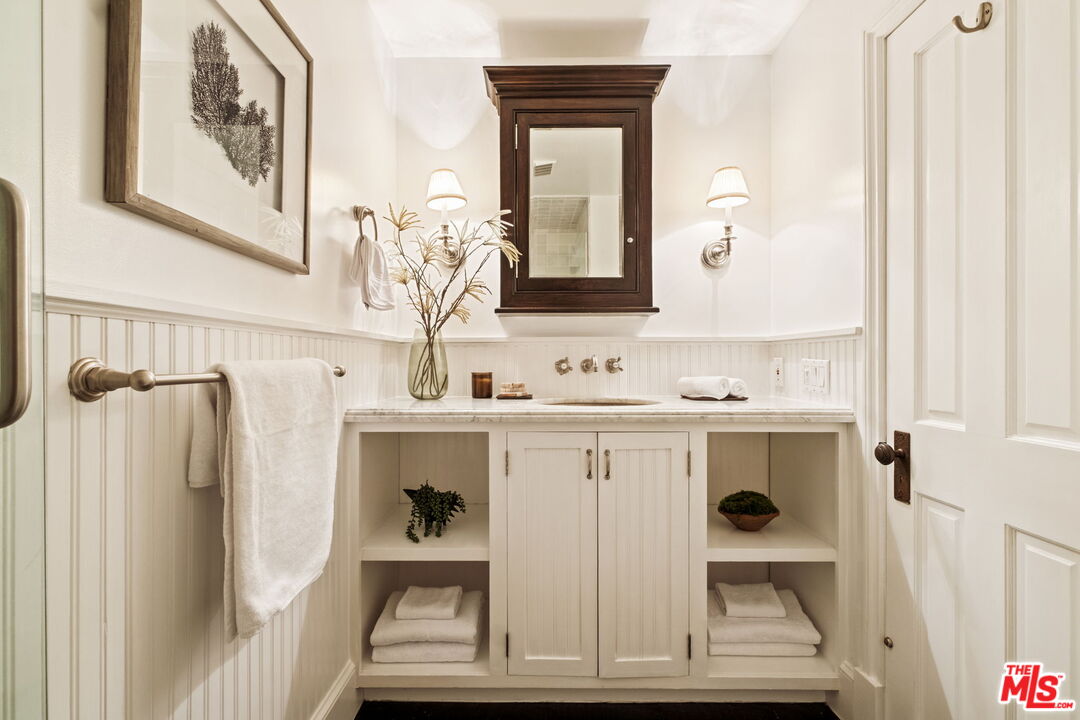 8455 Fountain Avenue, Unit 411 West Hollywood, CA 90069 - Photo 23 of 27 a bathroom with a sink and a mirror