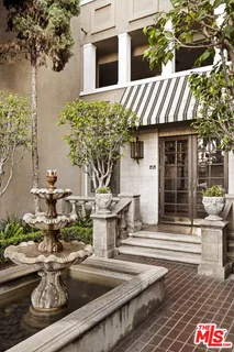 a front view of a house with fountain