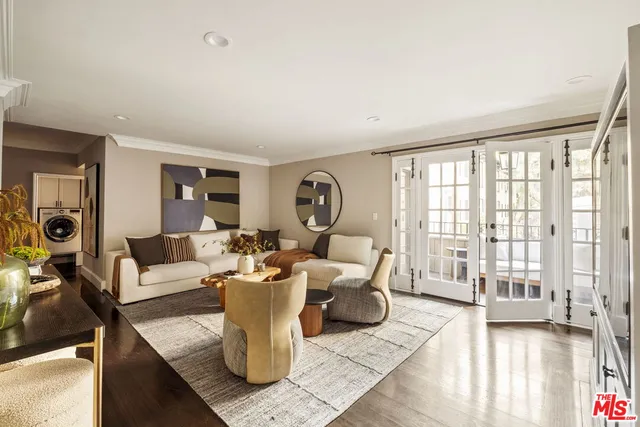 a living room with furniture and a mirror