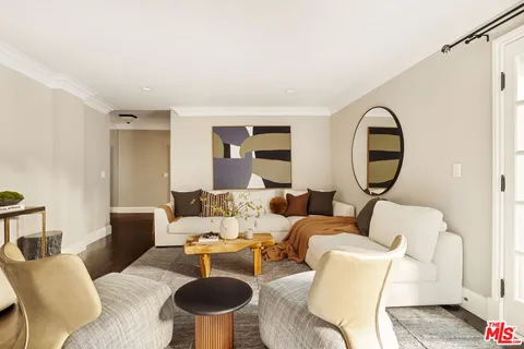 a living room with furniture and a mirror