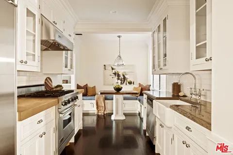 a kitchen with stainless steel appliances sink stove top oven and cabinets