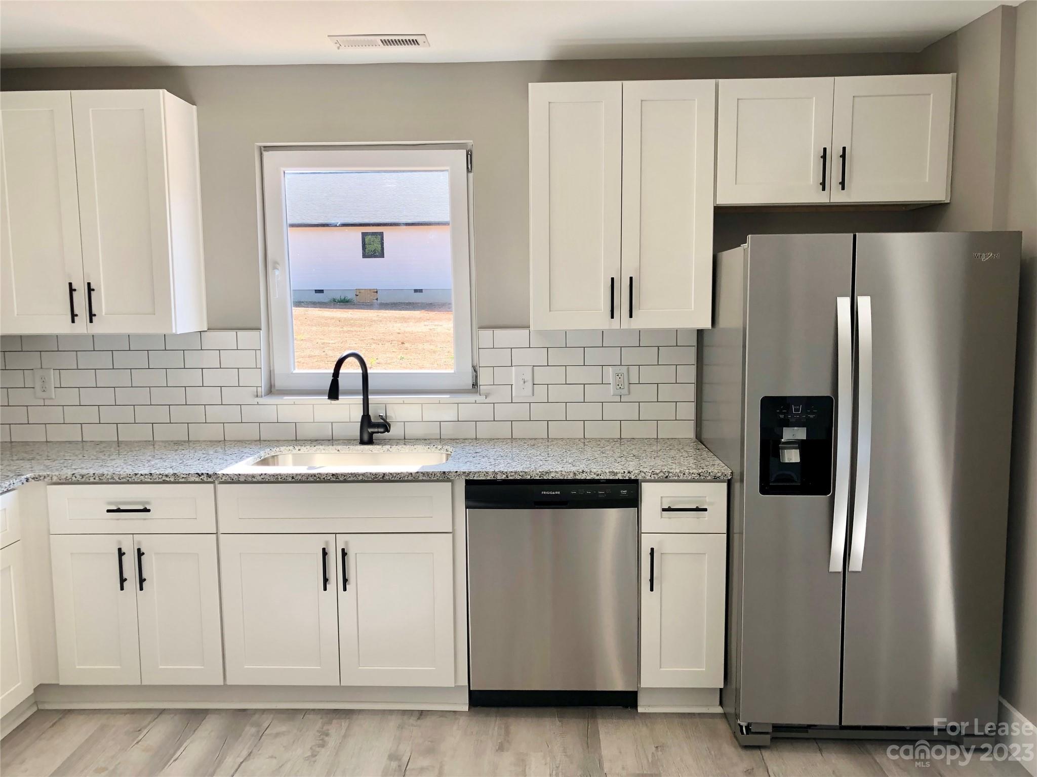 2435 Laboratory Road Lincolnton, NC 28092 - Photo 3 of 19 a kitchen with white cabinets and refrigerator