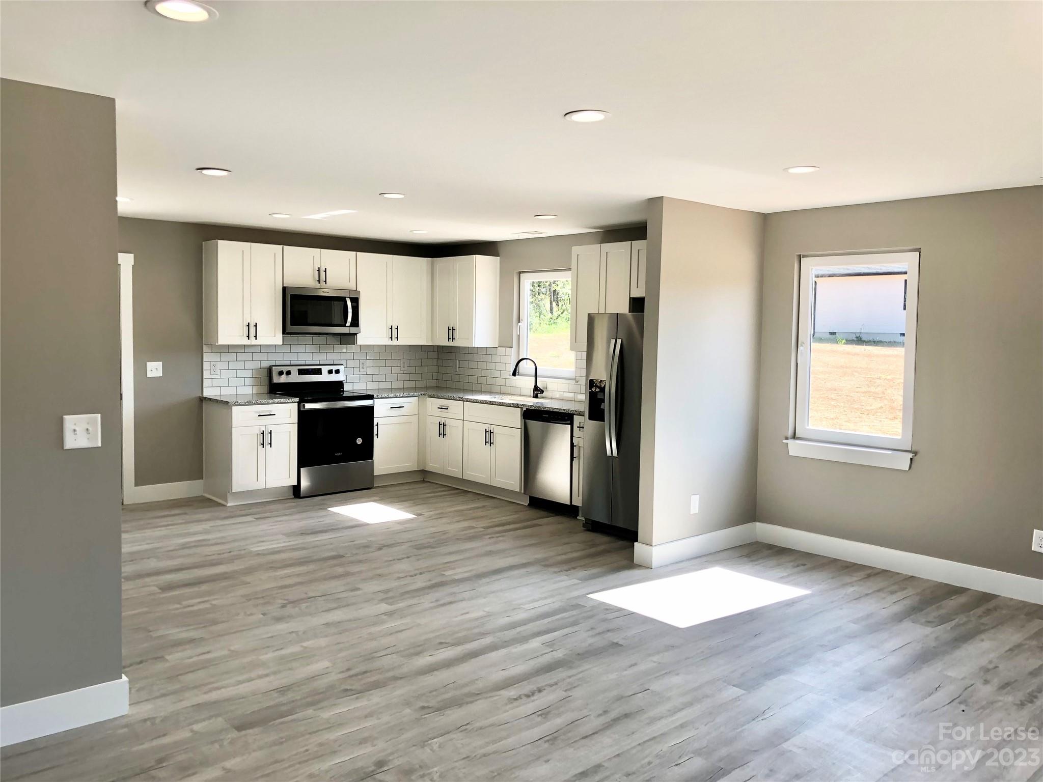 2435 Laboratory Road Lincolnton, NC 28092 - Photo 5 of 19 a kitchen with stainless steel appliances granite countertop a stove top oven a sink and a refrigerator