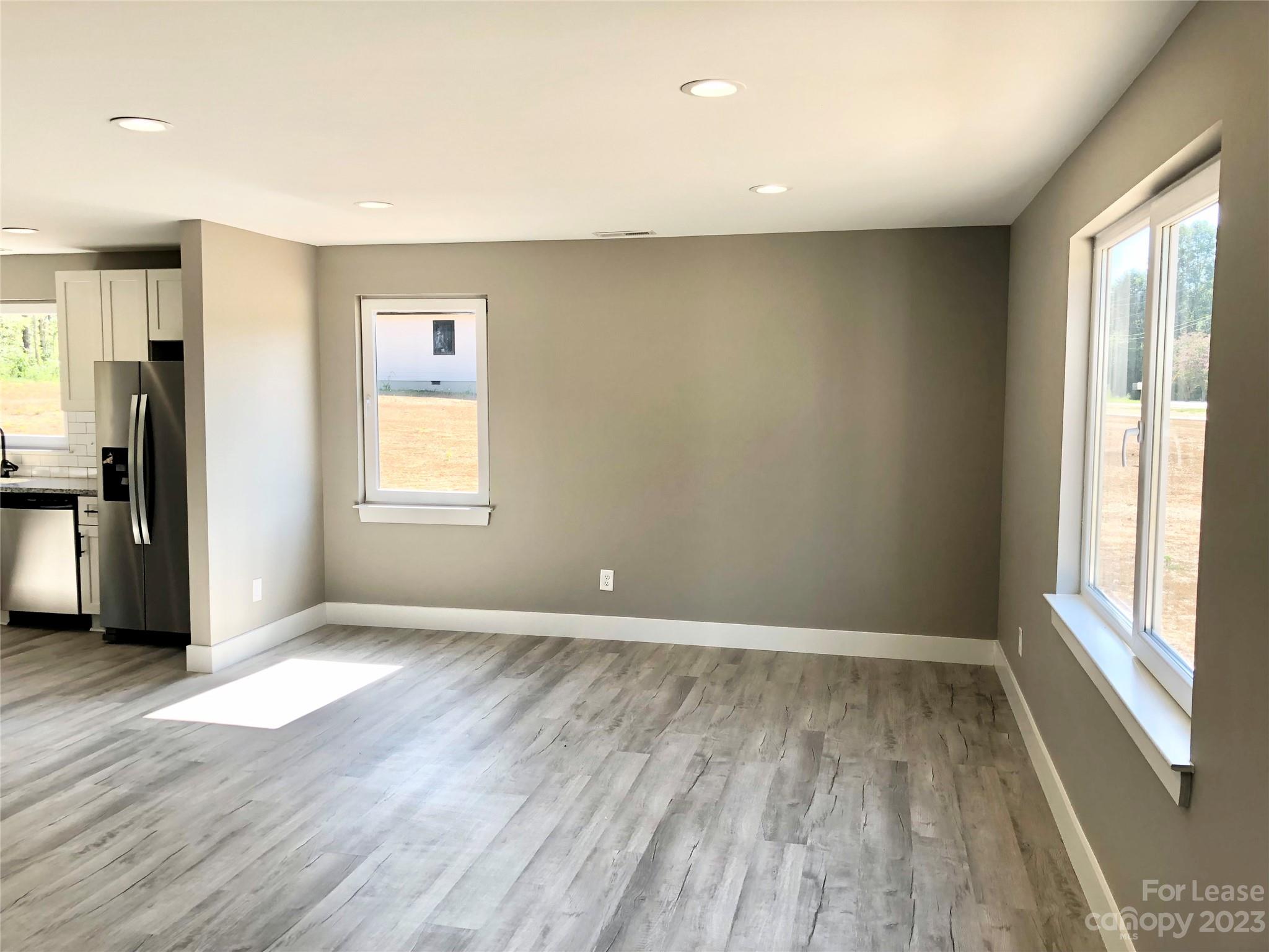 2435 Laboratory Road Lincolnton, NC 28092 - Photo 6 of 19 an empty room with wooden floor and windows