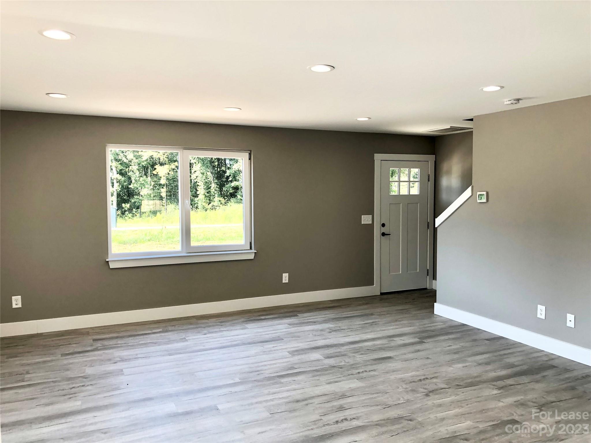 2435 Laboratory Road Lincolnton, NC 28092 - Photo 8 of 19 an empty room with wooden floor and windows