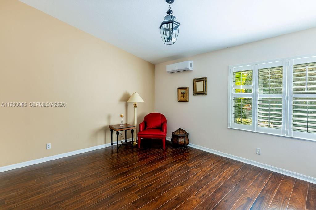 6050 Heliconia Road, Unit 6050 Delray Beach, FL 33484 - Photo 17 of 29 a room with furniture and wooden floor
