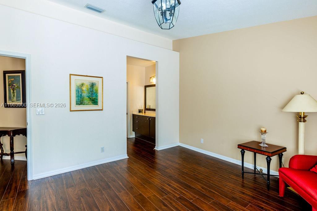 6050 Heliconia Road, Unit 6050 Delray Beach, FL 33484 - Photo 18 of 29 a view of a room with wooden floor lounge chair and windows