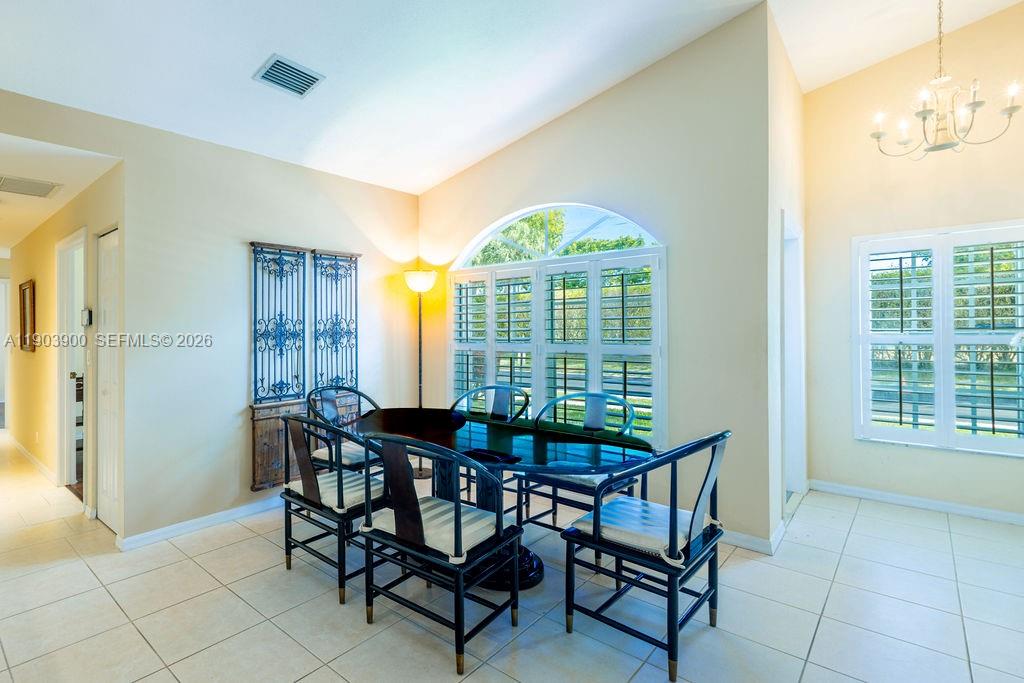 6050 Heliconia Road, Unit 6050 Delray Beach, FL 33484 - Photo 10 of 29 a dining room with furniture and window