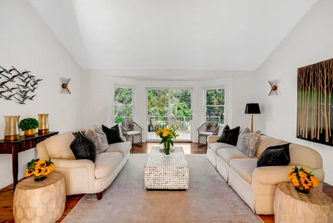 a living room with furniture and floor to ceiling window