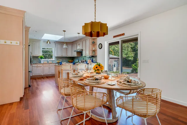 a dining room with furniture wooden floor a chandelier