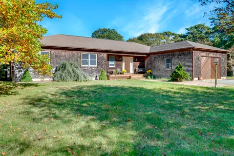 a front view of house with yard outdoor seating and green space