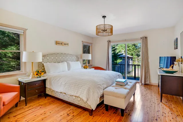 a bedroom with a bed and a large window