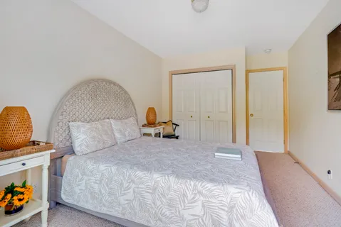 a bedroom with bed and a window