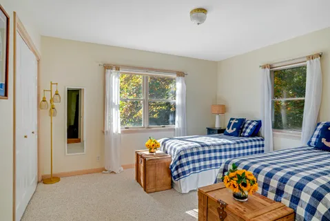 a bedroom with two beds and a window
