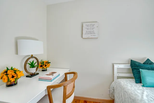 a bedroom with a bed and a chair with it