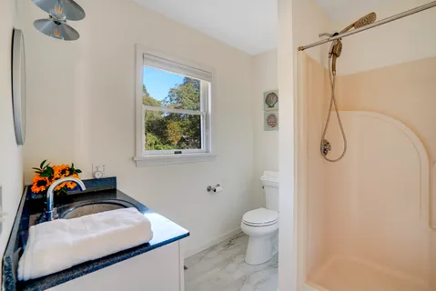 a bathroom with a sink toilet and shower