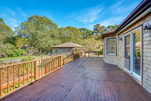 a view of a house with wooden deck