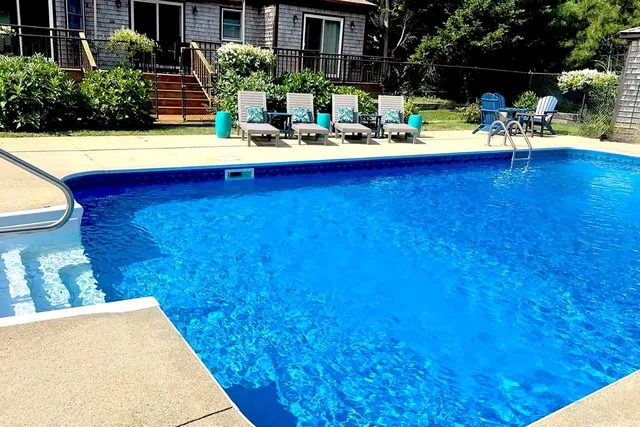 a view of swimming pool with outdoor seating