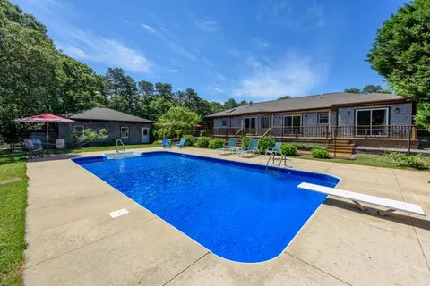 a view of swimming pool with outdoor seating and deck