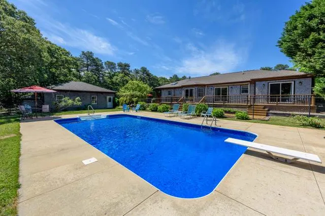 a view of swimming pool with outdoor seating and deck