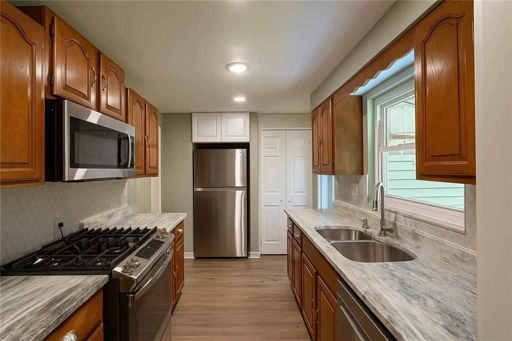 1535 Powers Run Road Pittsburgh, PA 15238 - Photo 5 of 22 a kitchen with a sink stove and refrigerator