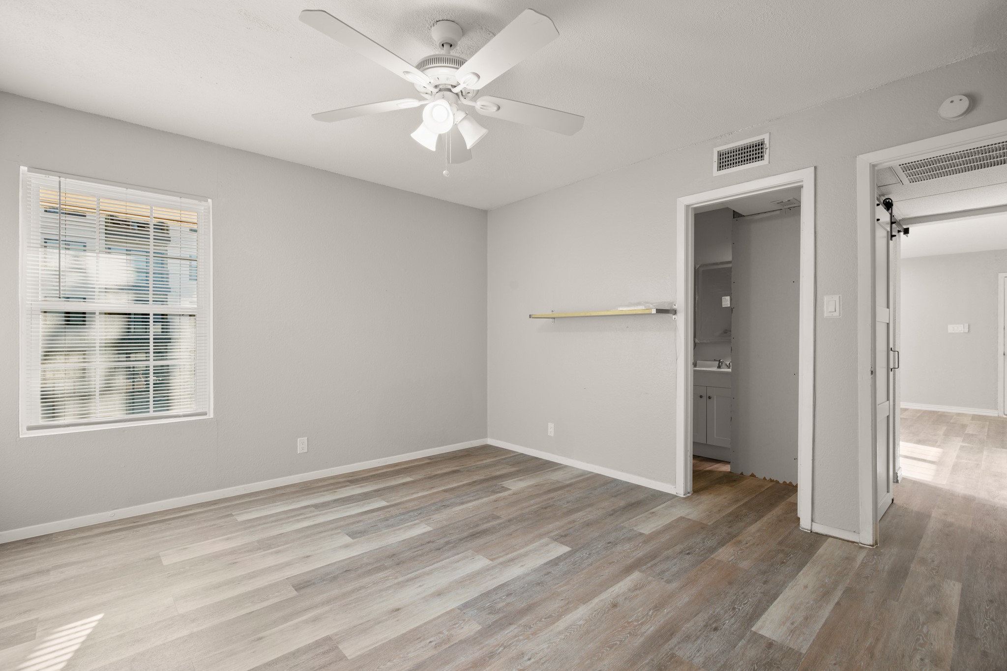910 Duncan Lane, Unit 56 Austin, TX 78705 - Photo 12 of 17 wooden floor in an empty room with a window