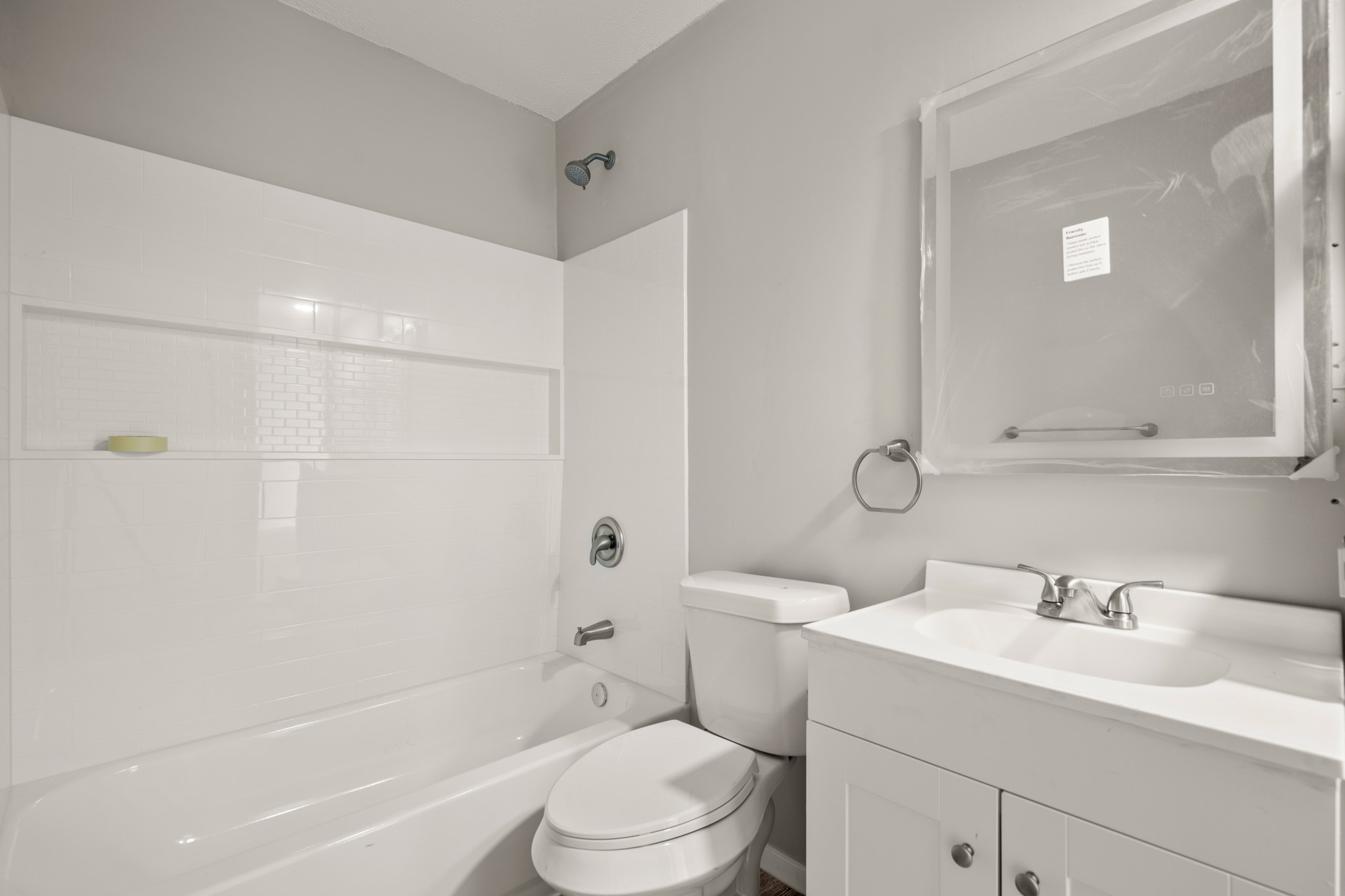 910 Duncan Lane, Unit 56 Austin, TX 78705 - Photo 13 of 17 a bathroom with a sink toilet vanity and shower