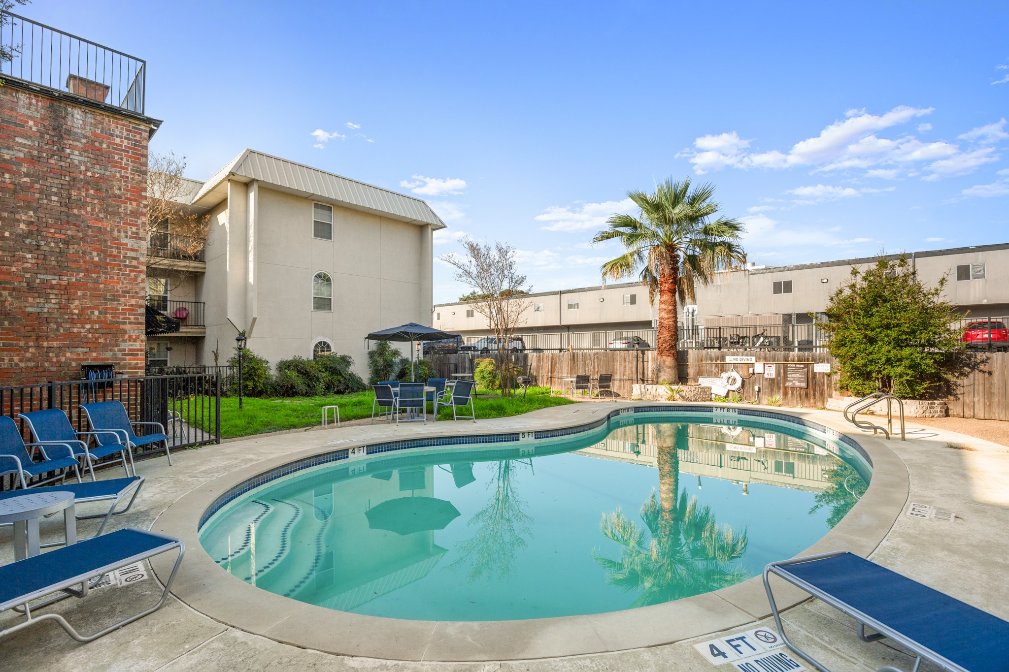 910 Duncan Lane, Unit 56 Austin, TX 78705 - Photo 16 of 17 a view of a swimming pool with a patio